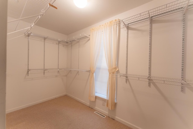 walk in closet with carpet floors and visible vents