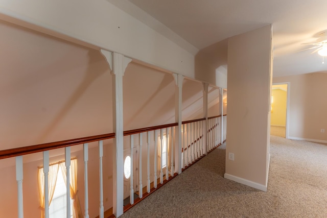 corridor with carpet flooring and baseboards