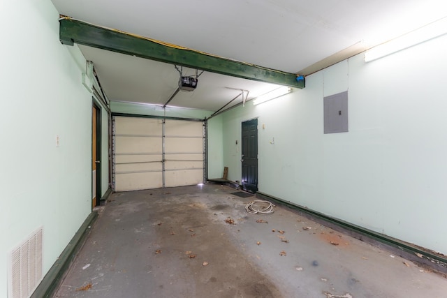 garage featuring electric panel, visible vents, and a garage door opener