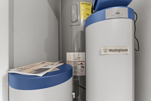 utility room featuring water heater and electric water heater