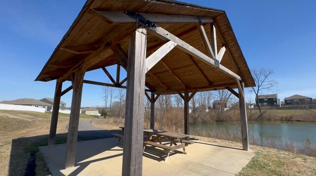 view of property's community featuring a patio and a water view