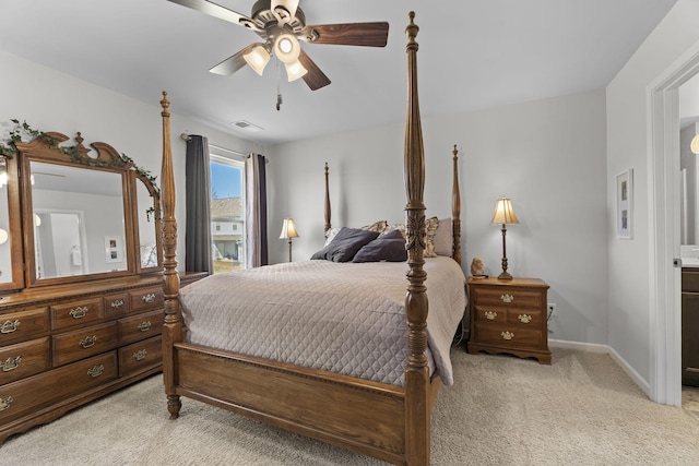 bedroom with light carpet, ceiling fan, visible vents, and baseboards