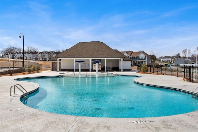 pool featuring a residential view, fence, and a patio