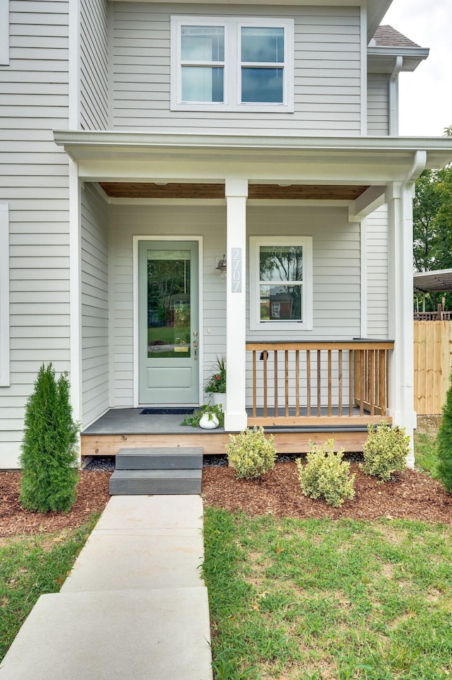 view of exterior entry with covered porch