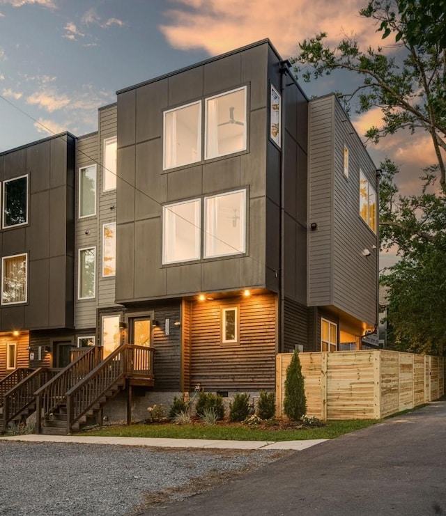 modern home featuring fence