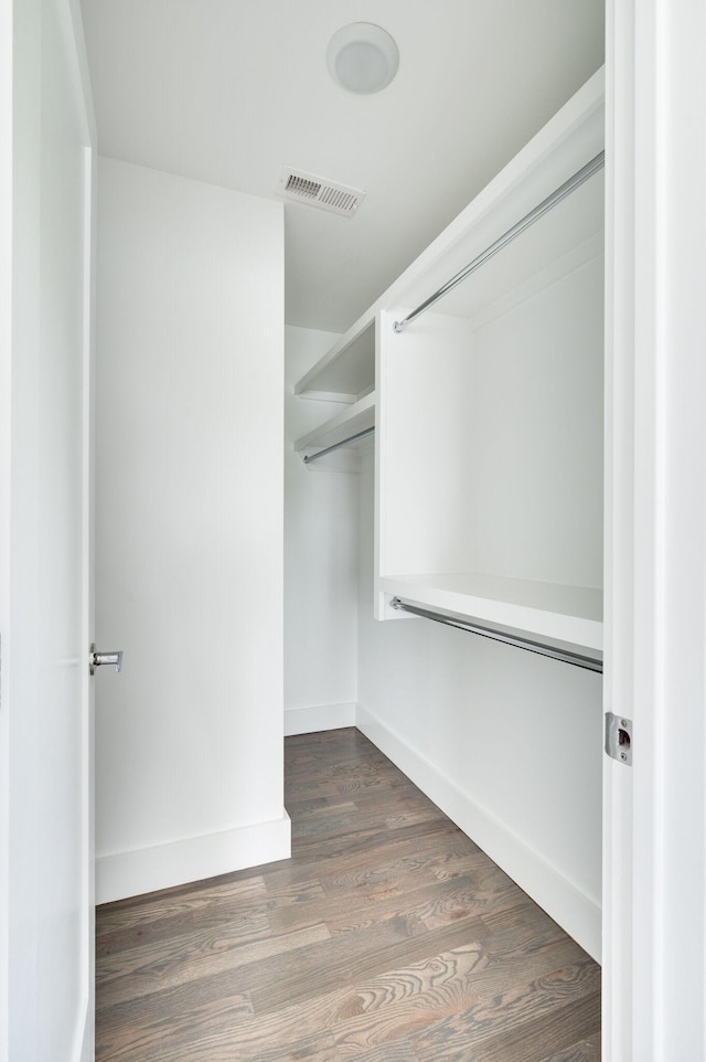 walk in closet featuring wood finished floors and visible vents