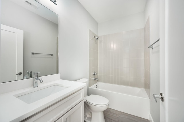 full bath with visible vents, vanity, toilet, and shower / bath combination