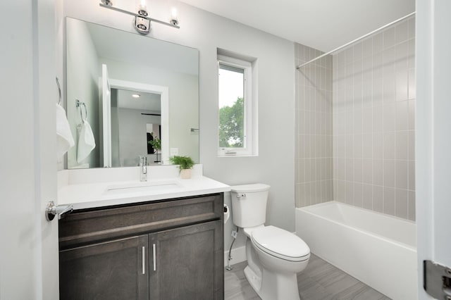 bathroom featuring vanity, toilet, and washtub / shower combination