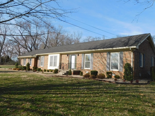 ranch-style home with brick siding and a front yard