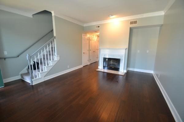 unfurnished living room featuring ornamental molding, stairway, and baseboards