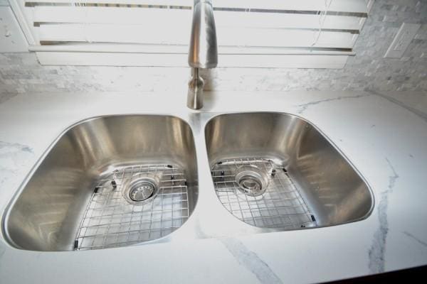 room details with light stone counters and a sink