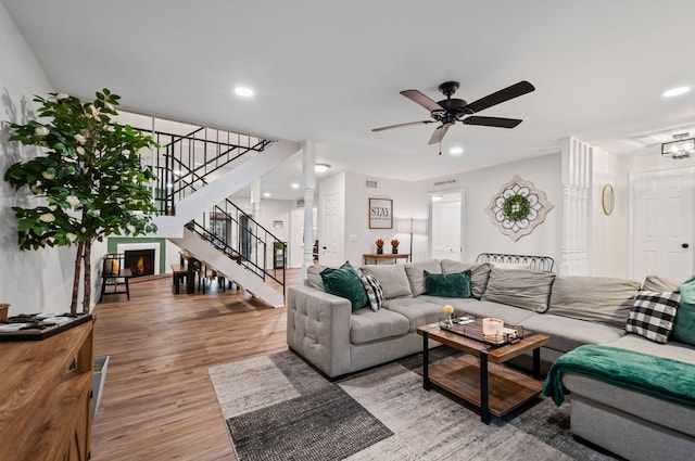 living room with recessed lighting, visible vents, stairway, light wood-style floors, and ceiling fan