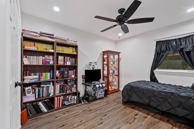 bedroom featuring wood finished floors, a ceiling fan, and recessed lighting