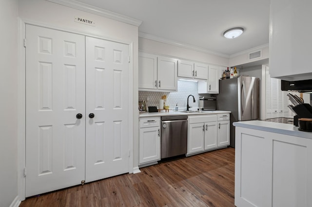 kitchen featuring appliances with stainless steel finishes, dark wood finished floors, white cabinetry, and crown molding