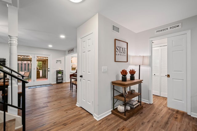 hall featuring recessed lighting, wood finished floors, visible vents, and baseboards