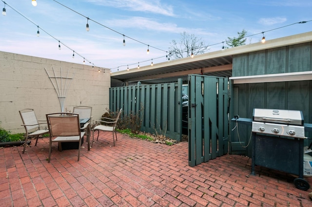 view of patio featuring fence, area for grilling, and outdoor dining space