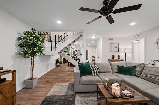 living room featuring recessed lighting, visible vents, stairway, wood finished floors, and baseboards