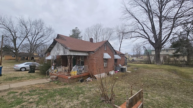 view of property exterior with a yard and a chimney