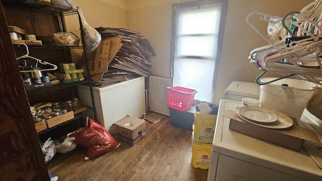 laundry area with laundry area, wood finished floors, and washer and dryer