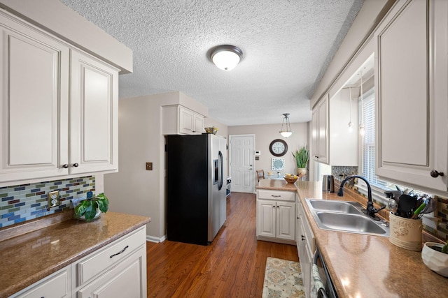 kitchen with tasteful backsplash, light wood-style flooring, white cabinetry, stainless steel refrigerator with ice dispenser, and a sink