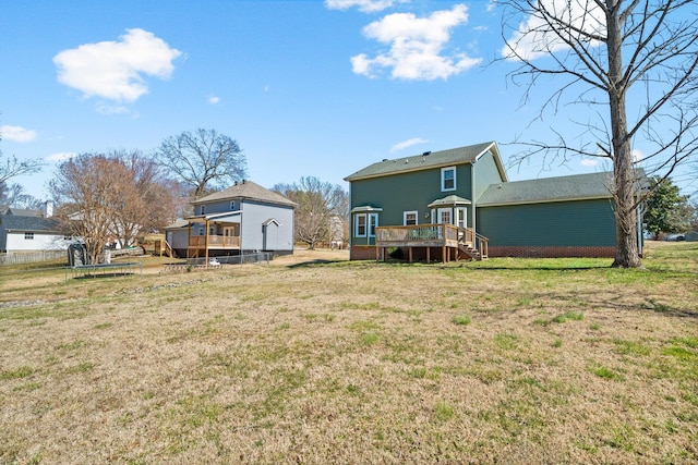 back of house with a lawn and a wooden deck