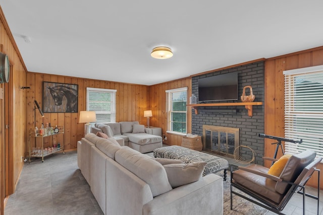 living room with a brick fireplace and wooden walls