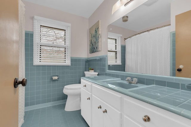 full bathroom featuring a healthy amount of sunlight, tile patterned flooring, toilet, and tile walls