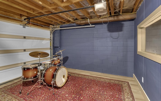 interior space featuring concrete block wall and a garage door opener