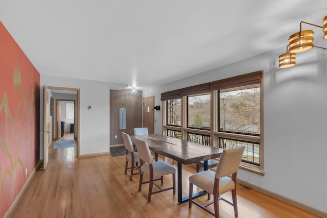 dining space with light wood-style floors and baseboards