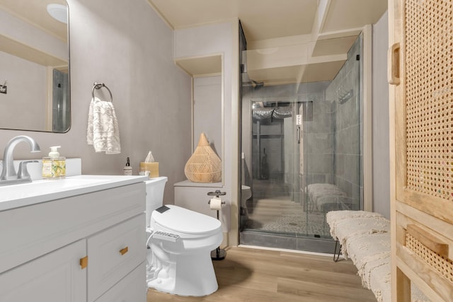 full bathroom featuring toilet, a shower stall, wood finished floors, and vanity