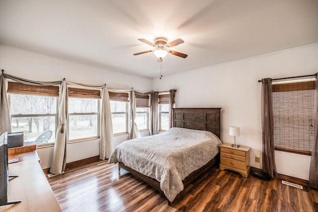 bedroom featuring ceiling fan, baseboards, and dark wood-type flooring