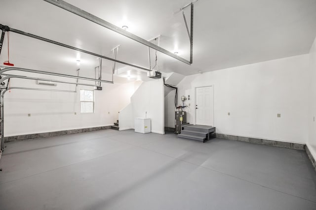 garage featuring water heater, baseboards, and a garage door opener