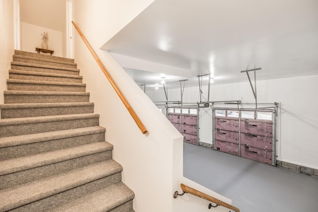 staircase featuring finished concrete floors