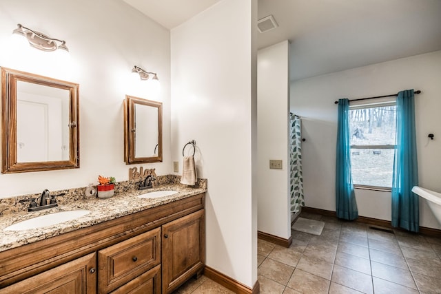 full bathroom featuring tile patterned floors, visible vents, a sink, and double vanity