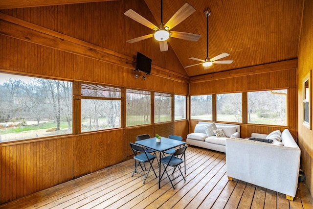 sunroom / solarium with lofted ceiling and a ceiling fan