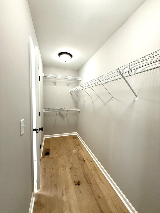 spacious closet with wood finished floors and visible vents