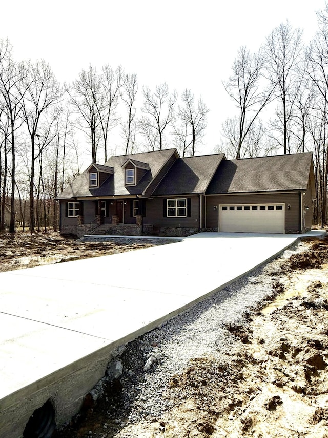 view of front of home with concrete driveway and an attached garage