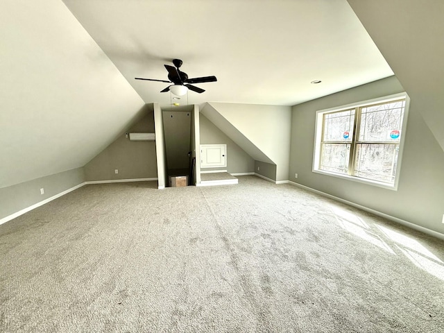 additional living space with carpet floors, vaulted ceiling, baseboards, and ceiling fan