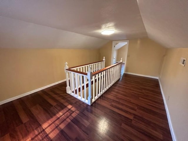 bonus room featuring lofted ceiling, baseboards, and wood finished floors