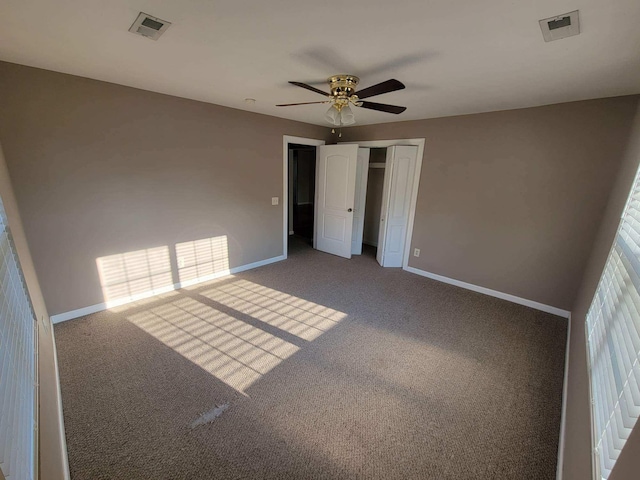 unfurnished bedroom featuring carpet, visible vents, and baseboards