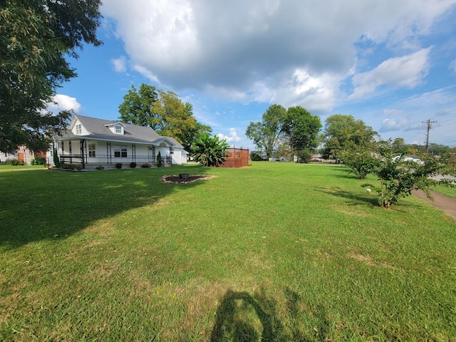 view of yard featuring an outdoor fire pit