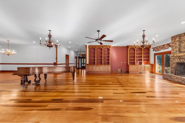 living area featuring ceiling fan with notable chandelier, wood finished floors, and recessed lighting