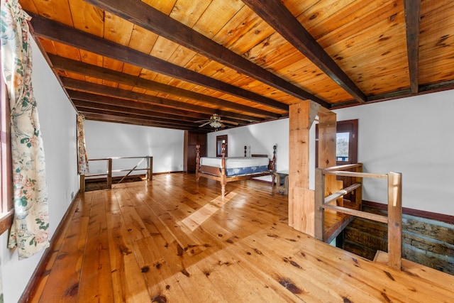 unfurnished bedroom featuring wooden ceiling, beamed ceiling, baseboards, and hardwood / wood-style flooring