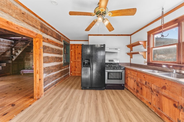 kitchen with open shelves, a sink, gas range, under cabinet range hood, and black fridge