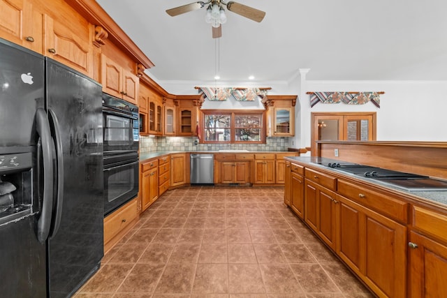 kitchen with brown cabinets, tasteful backsplash, glass insert cabinets, ornamental molding, and black appliances