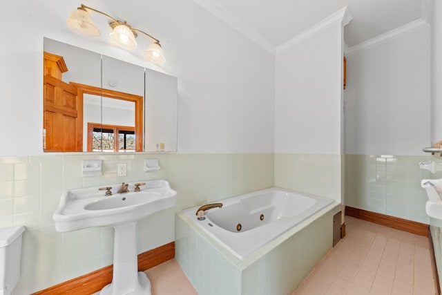 bathroom featuring a wainscoted wall, a tub with jets, ornamental molding, tile patterned floors, and tile walls