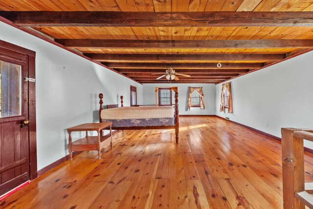 basement featuring wooden ceiling, baseboards, ceiling fan, and hardwood / wood-style floors