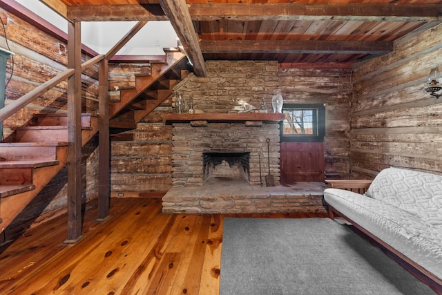 living room with wood ceiling, a fireplace, beam ceiling, and hardwood / wood-style floors