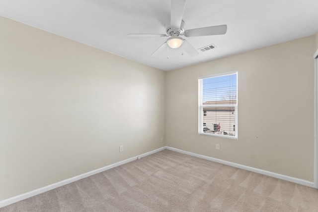 unfurnished room featuring light carpet, ceiling fan, visible vents, and baseboards