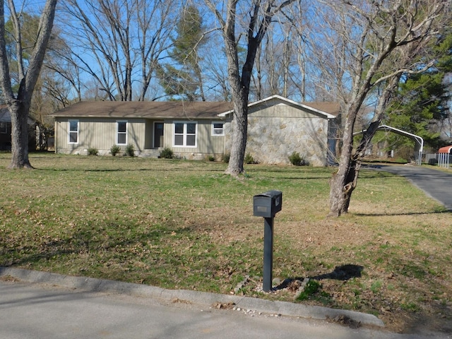 view of front of house with a carport and a front lawn